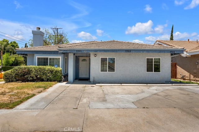 7701 Baird Ave, Reseda, CA 91335 - ranch-style home featuring stucco siding, a chimney, and a tile roof
