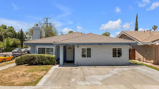 7701 Baird Ave, Reseda, CA 91335 - ranch-style home featuring stucco siding, a tile roof, and a chimney