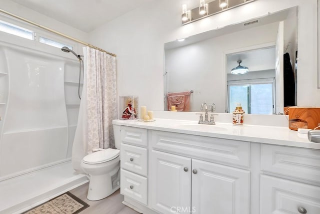 7701 Baird Ave, Reseda, CA 91335 - bathroom featuring vanity, toilet, curtained shower, and plenty of natural light