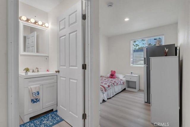 7701 Baird Ave, Reseda, CA 91335 - bathroom featuring vanity, ensuite bath, and wood finished floors