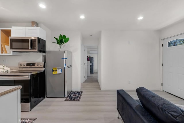 7701 Baird Ave, Reseda, CA 91335 - kitchen featuring stainless steel appliances, light wood-type flooring, white cabinetry, baseboards, and recessed lighting