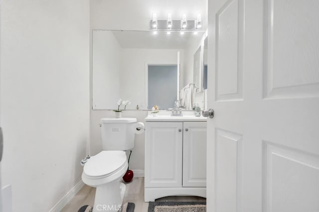 7701 Baird Ave, Reseda, CA 91335 - half bathroom with vanity, toilet, baseboards, and wood finished floors