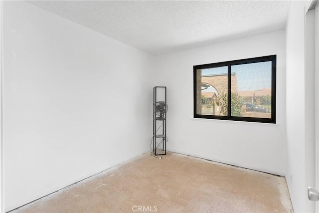 9820 Mandalay Ct, Riverside, CA 92503 - empty room with a textured ceiling and concrete flooring