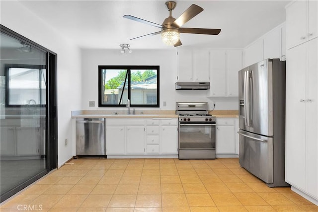 9820 Mandalay Ct, Riverside, CA 92503 - kitchen with stainless steel appliances, a sink, under cabinet range hood, light countertops, and ceiling fan