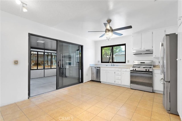 9820 Mandalay Ct, Riverside, CA 92503 - kitchen with stainless steel appliances, under cabinet range hood, light countertops, a sink, and white cabinetry