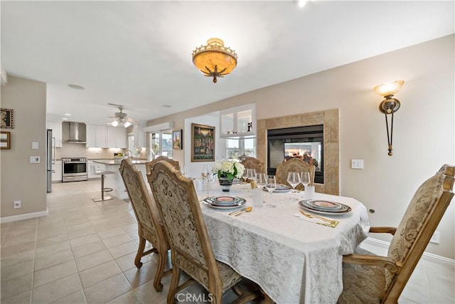 32070 Corte Bonilio, Temecula, CA 92592 - dining area featuring ceiling fan, light tile patterned floors, and a fireplace