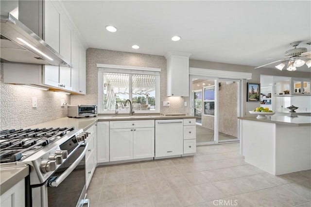 32070 Corte Bonilio, Temecula, CA 92592 - kitchen featuring wall chimney range hood, dishwasher, stainless steel range with gas stovetop, tasteful backsplash, and white cabinetry