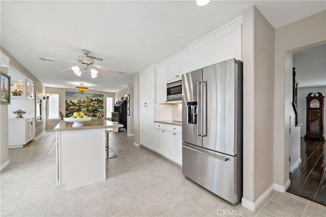 32070 Corte Bonilio, Temecula, CA 92592 - kitchen featuring stainless steel appliances, light tile patterned floors, a ceiling fan, and white cabinets