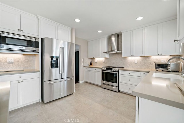 32070 Corte Bonilio, Temecula, CA 92592 - kitchen featuring stainless steel appliances, wall chimney range hood, white cabinets, tasteful backsplash, and recessed lighting
