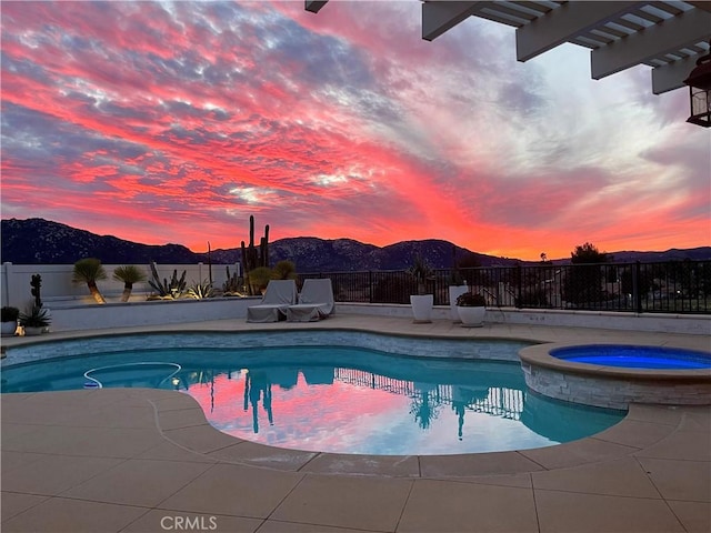 32070 Corte Bonilio, Temecula, CA 92592 - pool at dusk with a fenced backyard, a pool with connected hot tub, and a mountain view