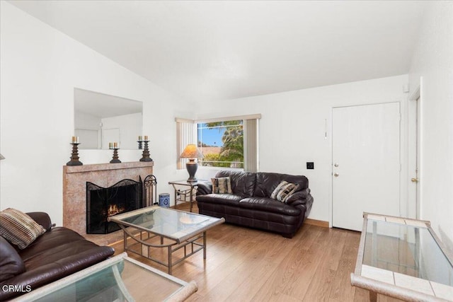 849 Plaza Cuernavaca Way, San Diego, CA 92114 - living area featuring a tile fireplace, vaulted ceiling, and light wood-style flooring