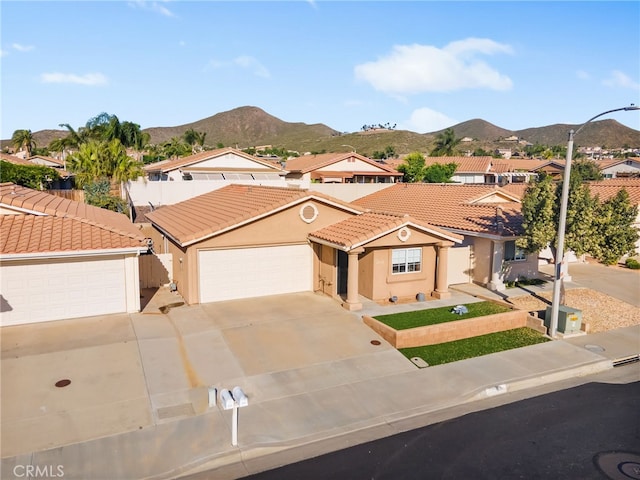 28162 Bavaria Dr, Menifee, CA 92585 - mediterranean / spanish-style house with a tiled roof, a mountain view, stucco siding, concrete driveway, and an attached garage