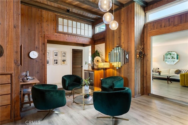 33252 Big Sur St, Dana Point, CA 92629 - living area with wooden walls, wood finished floors, a high ceiling, and a wood ceiling with exposed beams