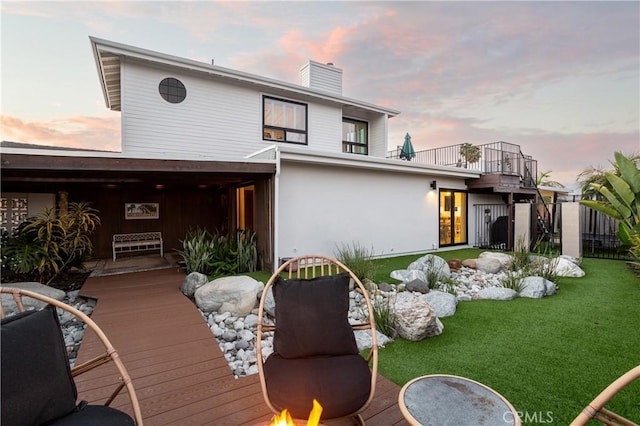 33252 Big Sur St, Dana Point, CA 92629 - back of house at dusk with a chimney, a yard, and a balcony