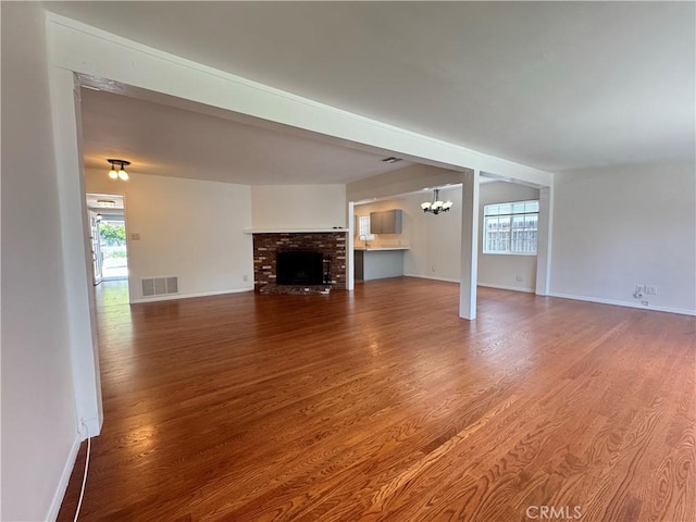 23308 Friar St, Woodland Hills, CA 91367 - unfurnished living room featuring wood finished floors, a chandelier, and a fireplace