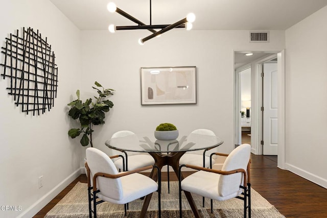 4000 Via Marisol 103, Los Angeles, CA 90042 - dining room with a chandelier, dark wood-type flooring, and baseboards