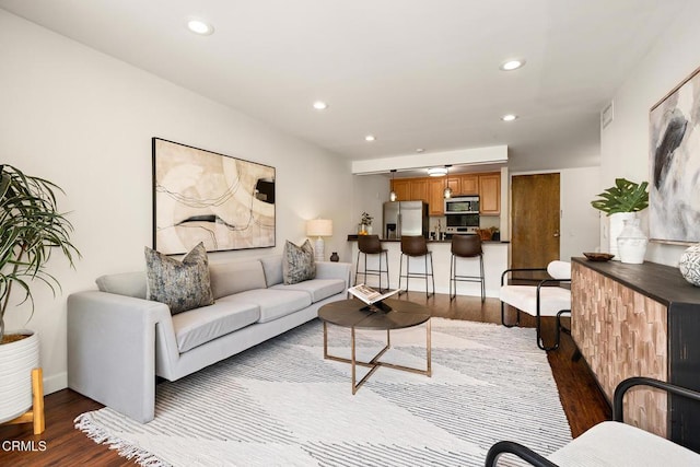 4000 Via Marisol 103, Los Angeles, CA 90042 - living room featuring dark wood finished floors, recessed lighting, and baseboards