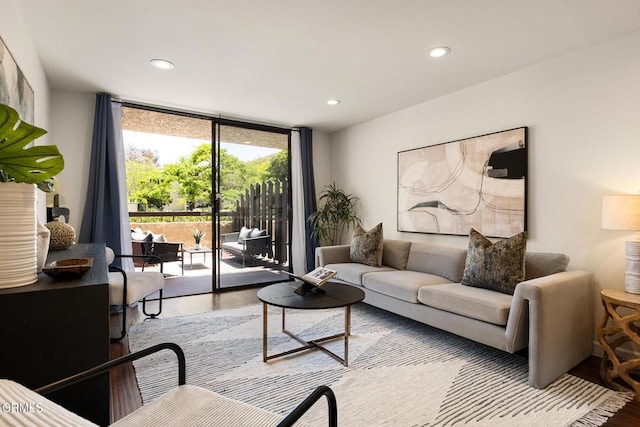 4000 Via Marisol 103, Los Angeles, CA 90042 - living area with a wall of windows, wood finished floors, and recessed lighting