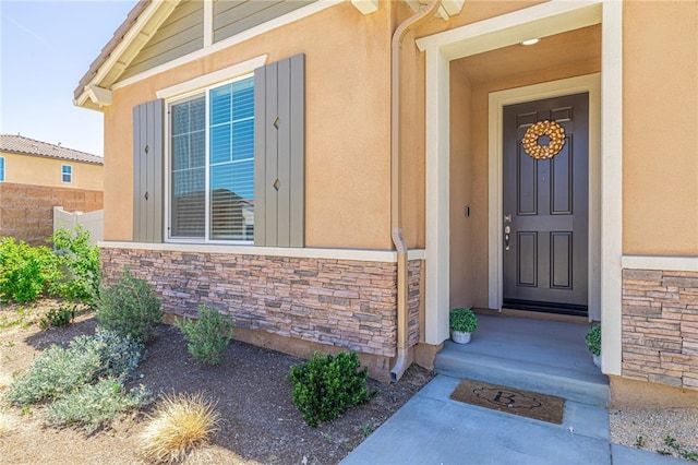 6118 W W Ave J9, Lancaster, CA 93536 - doorway to property featuring stone siding and stucco siding
