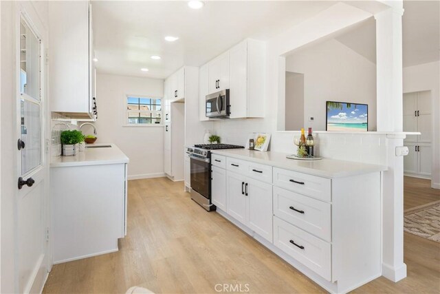 4519 Darien St, Torrance, CA 90503 - kitchen featuring stainless steel appliances, light wood finished floors, white cabinetry, light countertops, and recessed lighting