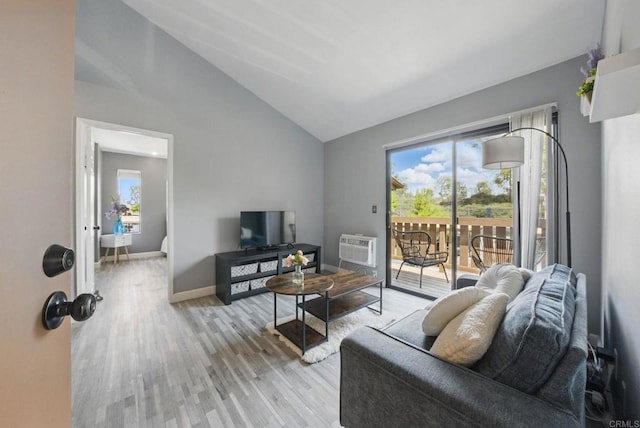 10296 Black Mountain Rd Unit 222, San Diego, CA 92126 - living room with lofted ceiling, light wood-type flooring, baseboards, and a wall unit AC