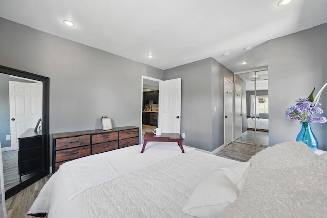 10296 Black Mountain Rd Unit 222, San Diego, CA 92126 - bedroom featuring wood finished floors, baseboards, recessed lighting, and a closet
