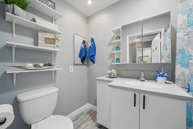 10296 Black Mountain Rd Unit 222, San Diego, CA 92126 - bathroom with toilet, wood finished floors, vanity, baseboards, and recessed lighting