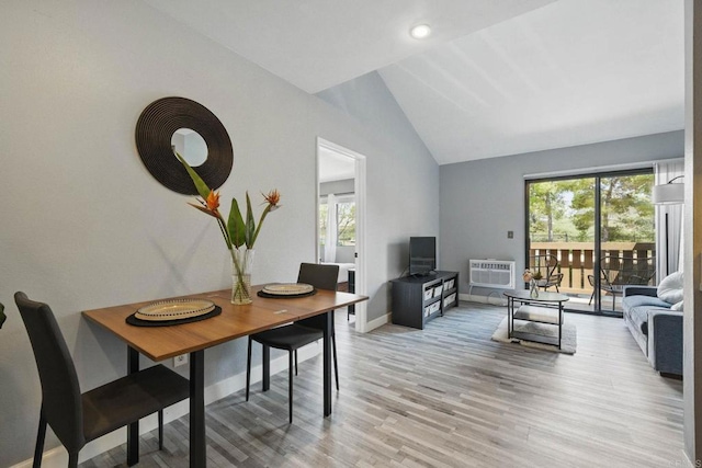 10296 Black Mountain Rd Unit 222, San Diego, CA 92126 - dining room featuring vaulted ceiling, light wood finished floors, a wall unit AC, and baseboards