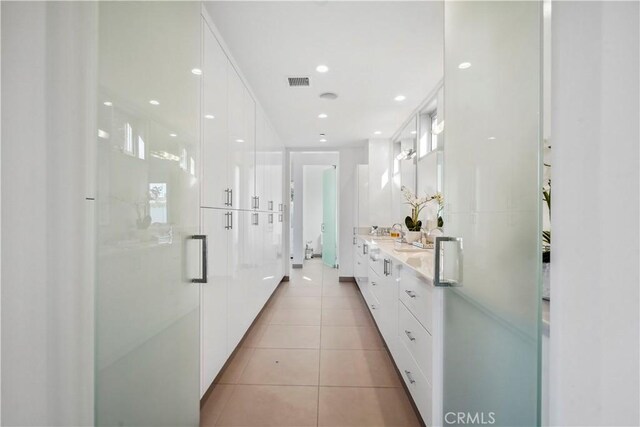9716 Oak Pass Rd, Beverly Hills, CA 90210 - bathroom featuring double vanity, tile patterned floors, and a shower stall