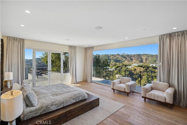 9716 Oak Pass Rd, Beverly Hills, CA 90210 - bedroom with access to exterior, light wood-type flooring, and recessed lighting