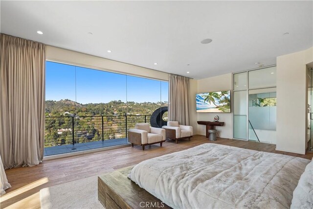 9716 Oak Pass Rd, Beverly Hills, CA 90210 - bedroom with wood finished floors and multiple windows