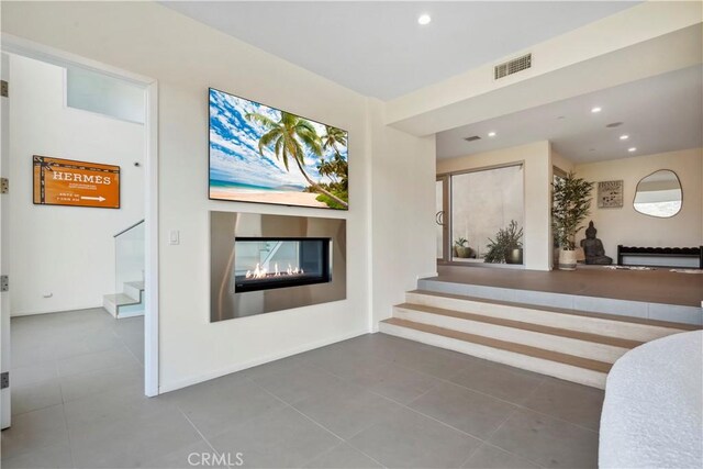 9716 Oak Pass Rd, Beverly Hills, CA 90210 - living room with a glass covered fireplace, stairs, tile patterned flooring, recessed lighting, and baseboards