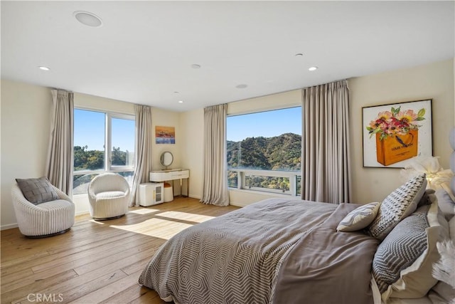 9716 Oak Pass Rd, Beverly Hills, CA 90210 - bedroom featuring multiple windows, light wood-type flooring, and recessed lighting