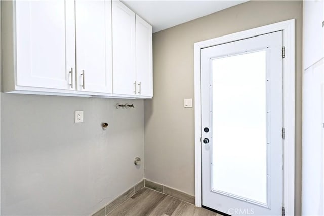 3624 Ardilla Ave, Baldwin Park, CA 91706 - laundry area featuring light wood-style floors, baseboards, and cabinet space
