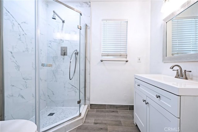 3624 Ardilla Ave, Baldwin Park, CA 91706 - bathroom featuring a marble finish shower, vanity, wood finish floors, and toilet