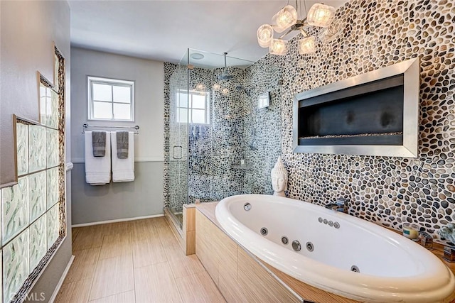 417 23rd St, Manhattan Beach, CA 90266 - full bathroom with a shower stall, a jetted tub, a chandelier, and baseboards