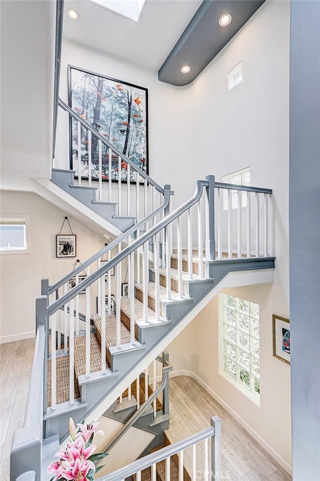 417 23rd St, Manhattan Beach, CA 90266 - stairway featuring recessed lighting, wood finished floors, a high ceiling, and baseboards