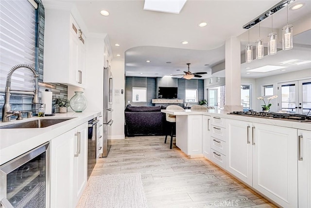 417 23rd St, Manhattan Beach, CA 90266 - kitchen featuring beverage cooler, stainless steel appliances, a sink, open floor plan, and recessed lighting