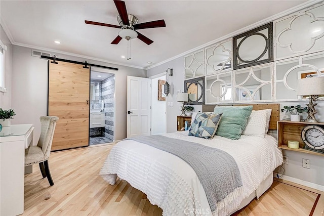 417 23rd St, Manhattan Beach, CA 90266 - bedroom with a barn door, wood finished floors, ornamental molding, connected bathroom, and recessed lighting