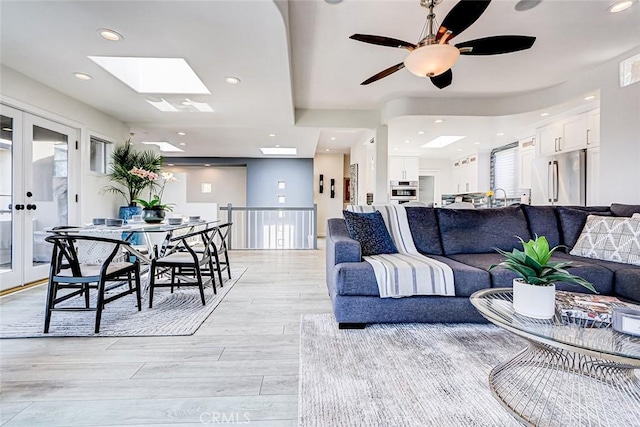 417 23rd St, Manhattan Beach, CA 90266 - living area with light wood-type flooring, recessed lighting, ceiling fan, french doors, and a skylight