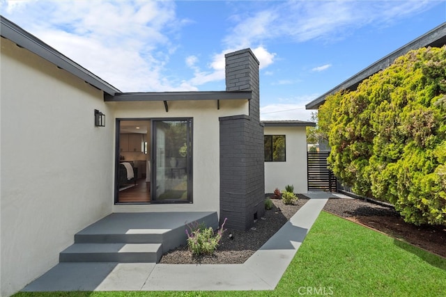 1792 Crestmont Pl, Costa Mesa, CA 92627 - entrance to property with a chimney, stucco siding, and a lawn