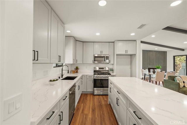 1792 Crestmont Pl, Costa Mesa, CA 92627 - kitchen with stainless steel appliances, recessed lighting, a sink, light stone countertops, and dark wood-style floors