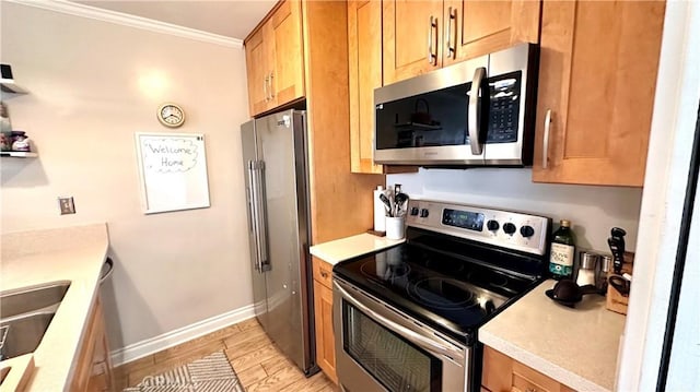 5951 Canterbury Dr Unit 17, Culver City, CA 90230 - kitchen with stainless steel appliances, ornamental molding, light countertops, baseboards, and a sink