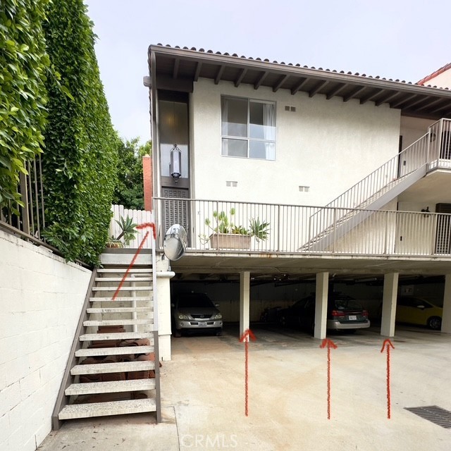 5951 Canterbury Dr Unit 17, Culver City, CA 90230 - rear view of property featuring stairway, stucco siding, and covered parking