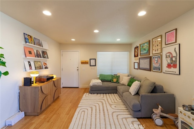 5706 Fair Ave Unit 100, North Hollywood, CA 91601 - living area featuring light wood finished floors, recessed lighting, baseboards, and a baseboard radiator