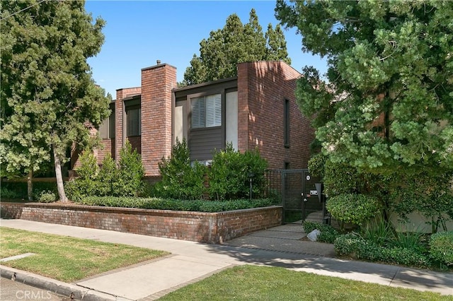 700 S Lake Ave Unit 305, Pasadena, CA 91106 - view of front of property featuring a gate and a chimney