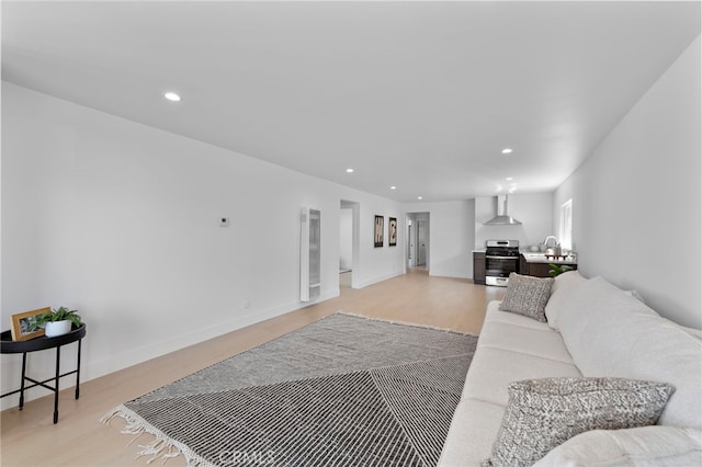 1005 E Cruces St, Wilmington, CA 90744 - living room with a heating unit, recessed lighting, light wood-type flooring, and baseboards