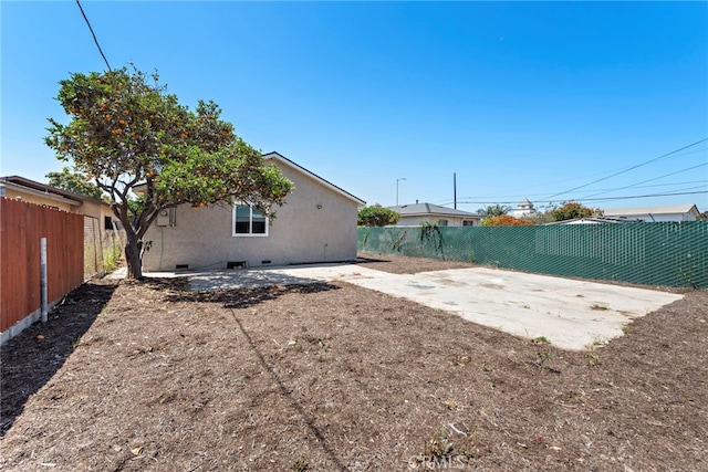 1005 E Cruces St, Wilmington, CA 90744 - back of property featuring a fenced backyard, crawl space, and a patio