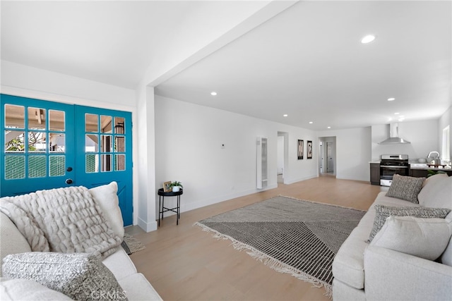 1005 E Cruces St, Wilmington, CA 90744 - living area featuring recessed lighting, light wood-style flooring, french doors, and baseboards