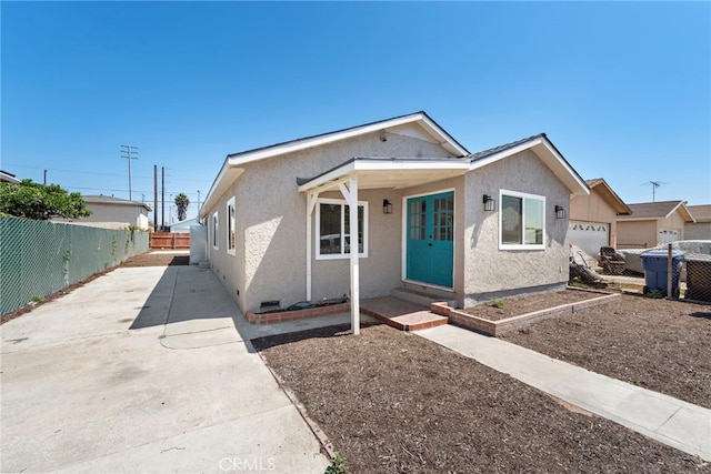 1005 E Cruces St, Wilmington, CA 90744 - view of front of house with a fenced backyard, stucco siding, and concrete driveway